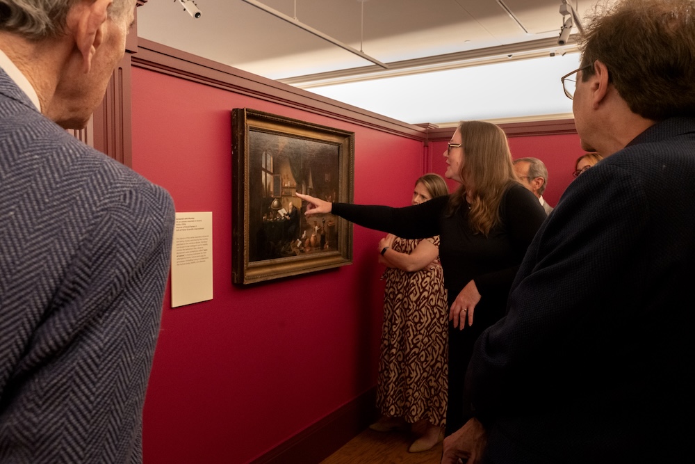 People gathered at a museum exhibit opening