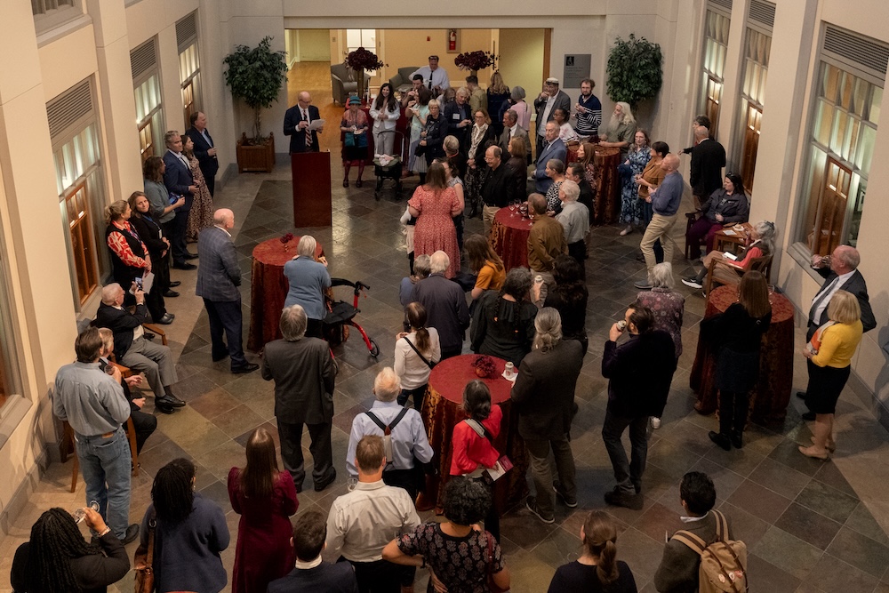 People gathered at a museum exhibit opening