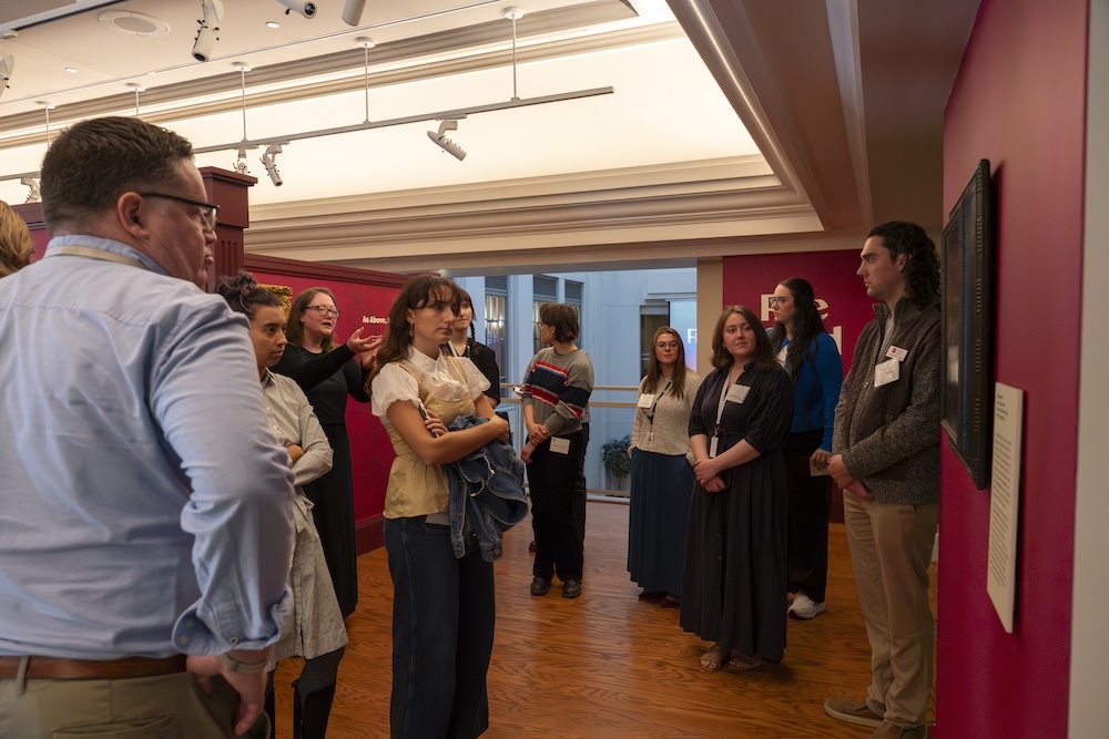 People gathered at a museum exhibit opening