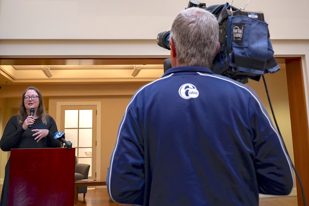 Woman being interviewed by a TV news camera