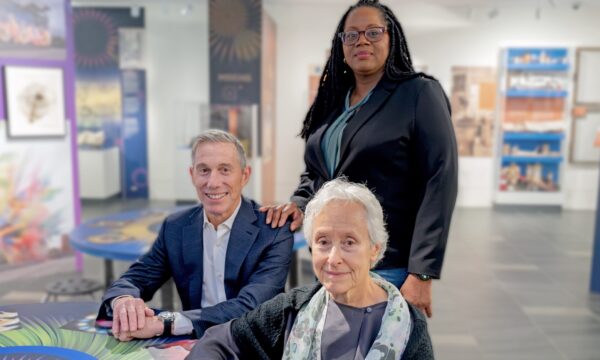 photo of 3 people in a museum
