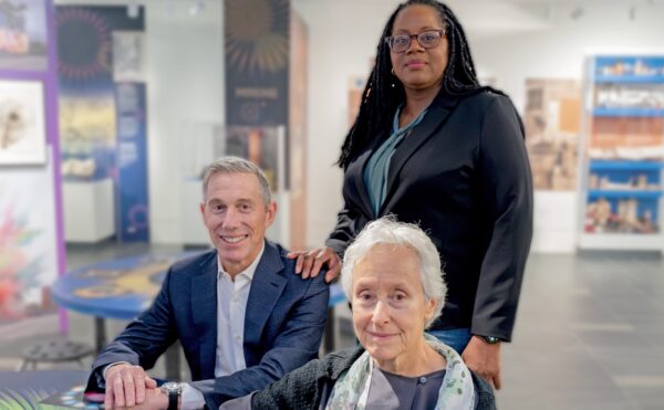 photo of 3 people in a museum