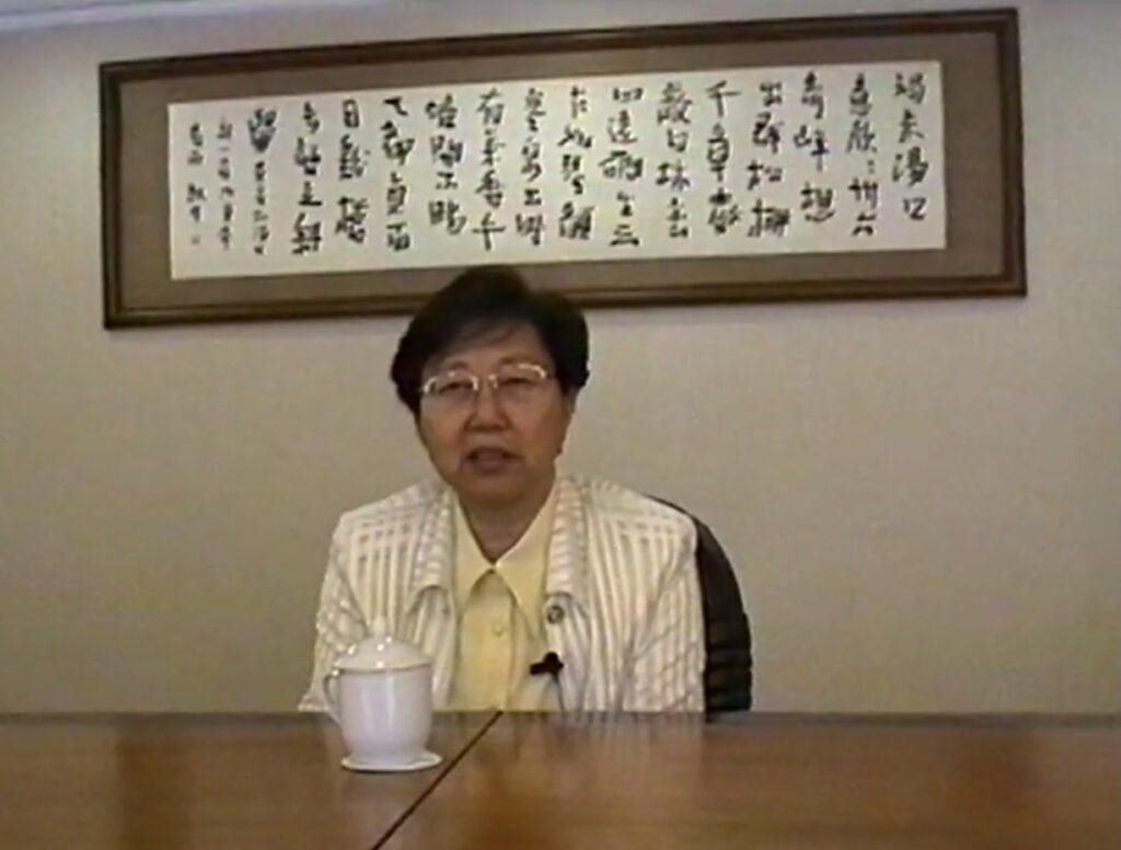 woman in glasses sitting at a table