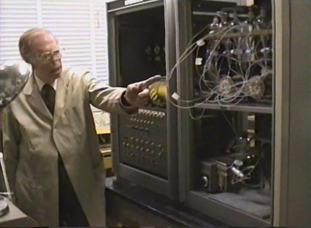 Man in front of a protein synthesizer